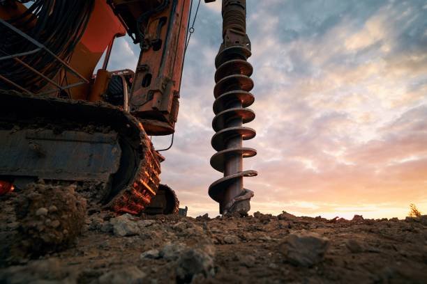 Technician performing tube well maintenance on a borehole pump